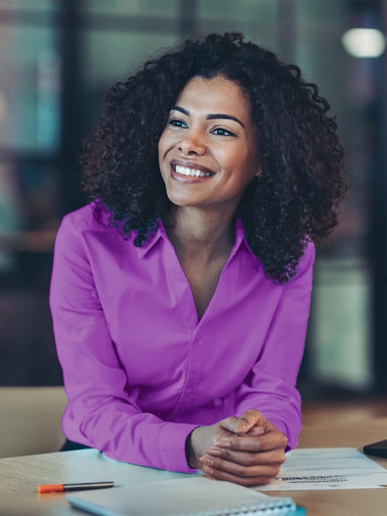 Happy business woman listening to a discussion in an office boardroom. Business professional sitting in a meeting with his colleagues.
