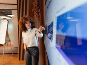 Young businesswoman pointing at monitor during a presentation in the office